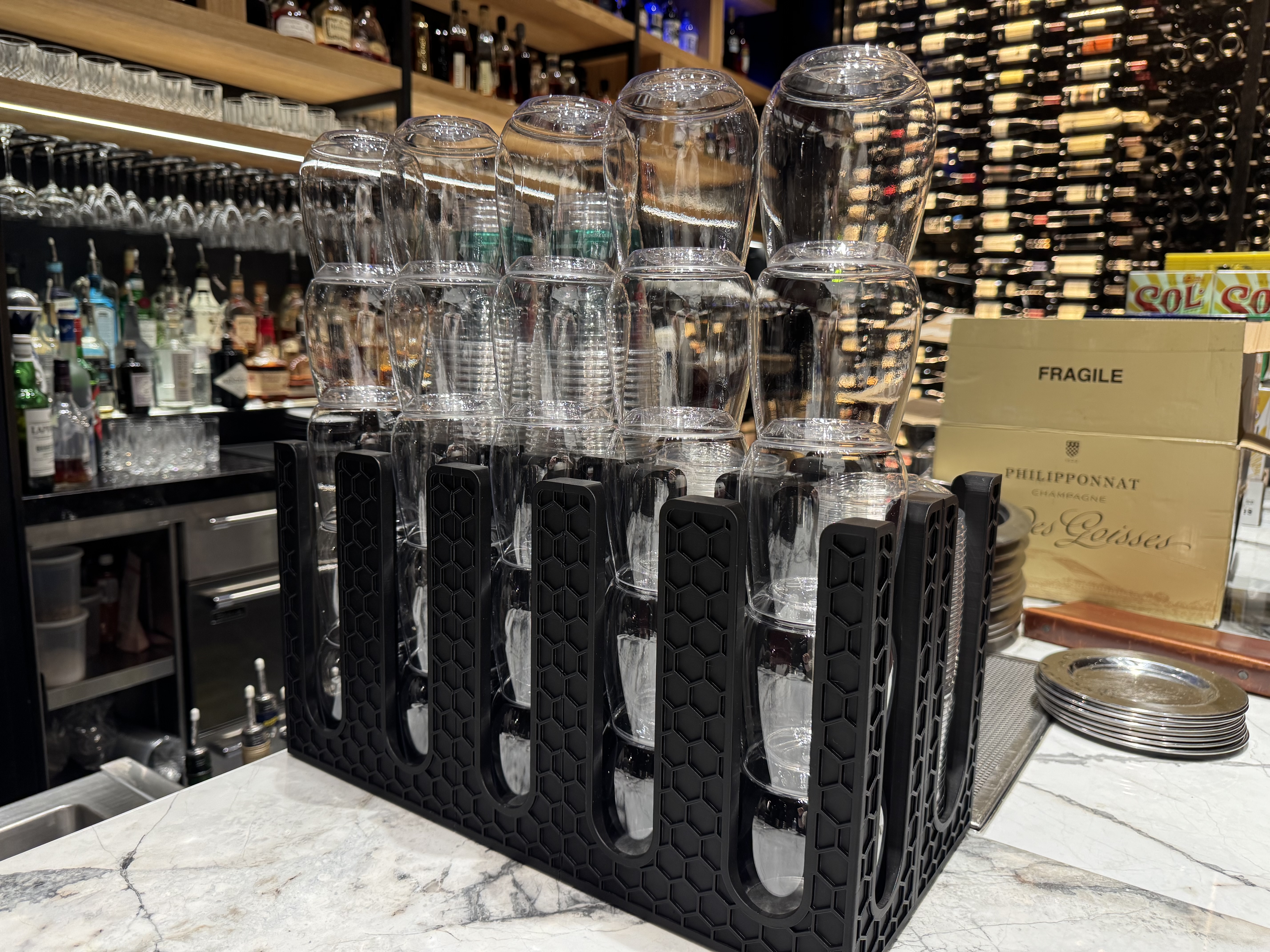 Custom black honeycomb organizers installed at a bar